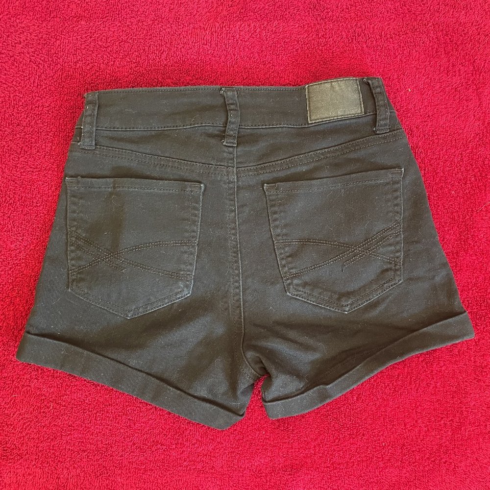 Black high-waisted midi jean shorts. Black denim. Size 0.